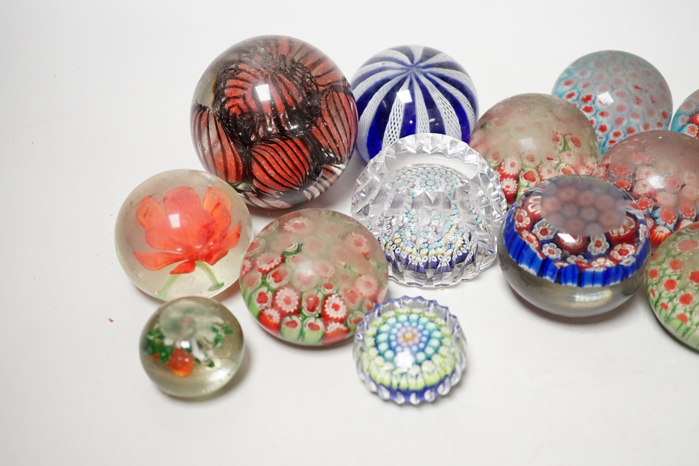A group of assorted glass paperweights, including a Perthshire type close-packed millefiori paperweight